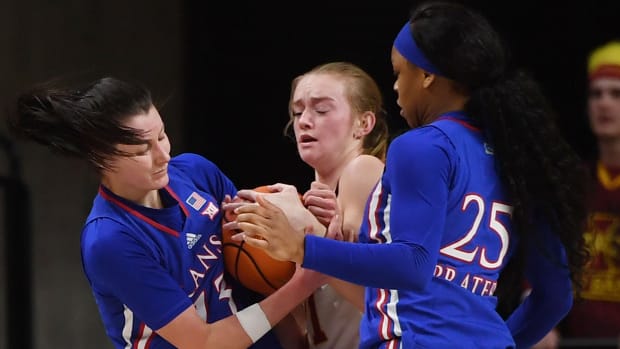 Iowa State Cyclones' guard Lexi Donarski (21) and Kansas' guard Holly Kersgieter (13) battle for the ball during the third quarter at Hilton Coliseum Wednesday, Jan. 26, 2022, in Ames, Iowa.